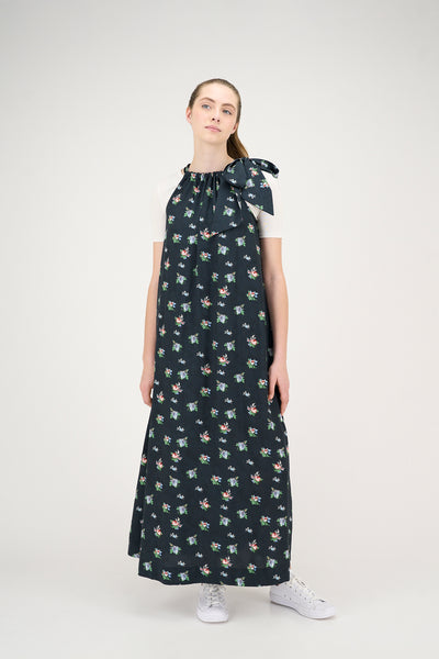 Woman wearing a dark floral jumper on a white background